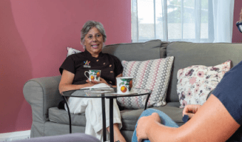 Therapist in support centre chatting drinking tea