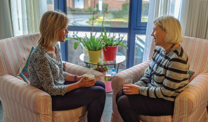 Two ladies chatting over tea