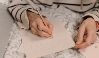 Image of a person writing on paper