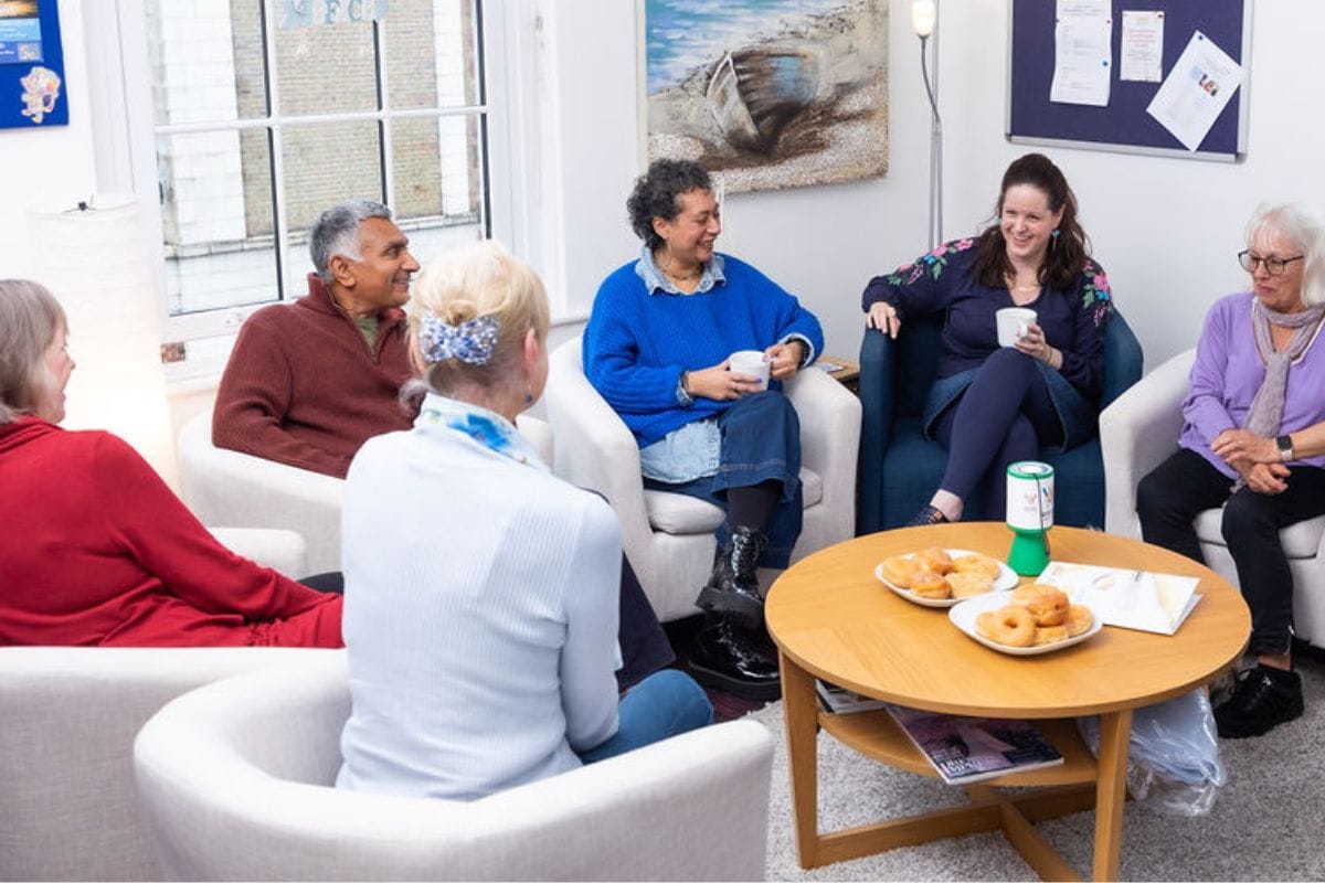 Image of group of people sitting in semi circle chatting