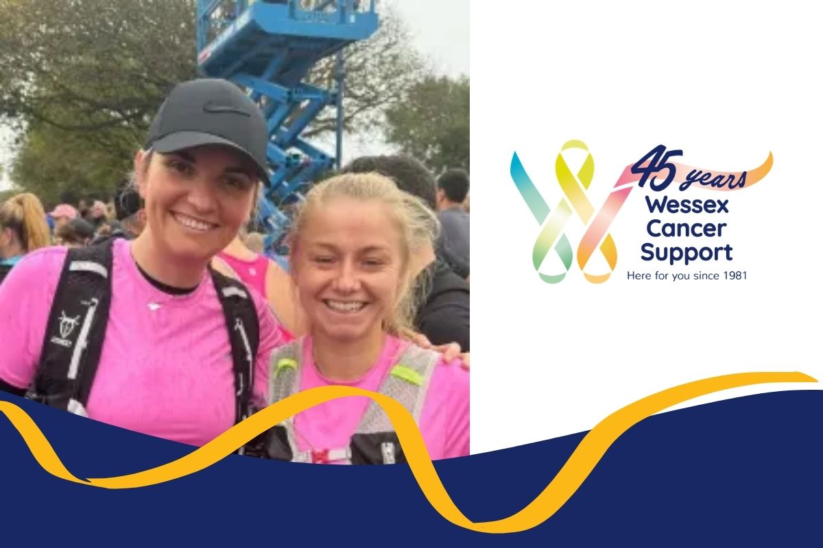 Photo shows two women from the shoulders up in bright pink t-shirts smiling to camera