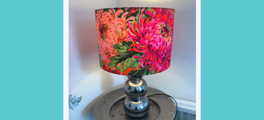 photo shows a pink flowery lampshade in a lamp